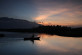 A fisherman rowing out onto Lago de Yojoa as the sun sets